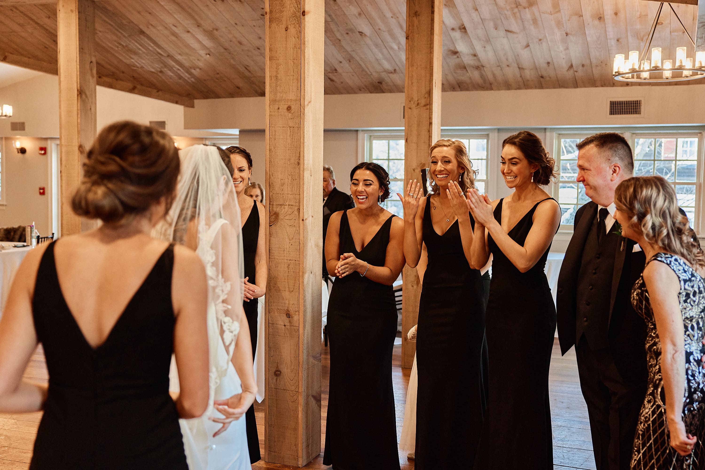 Candid photo of bridesmaids laughing and talking in a bridal suite